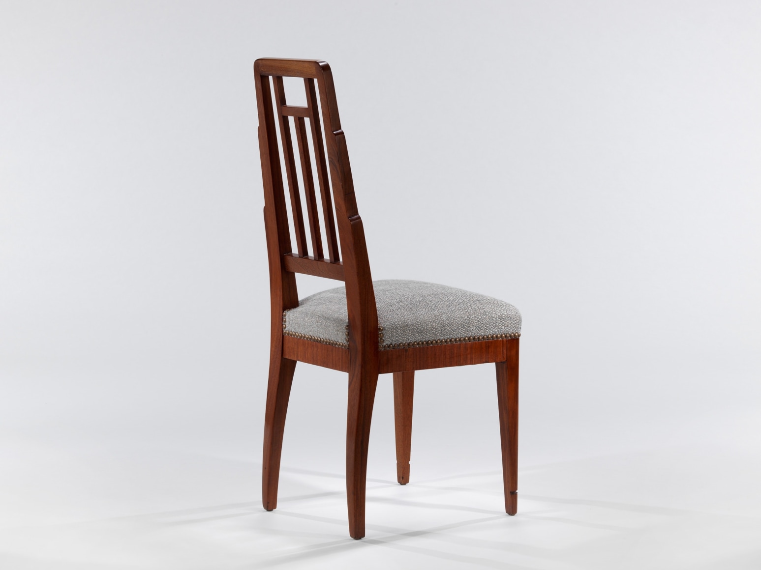 Back view of wood chair with upholstered seat