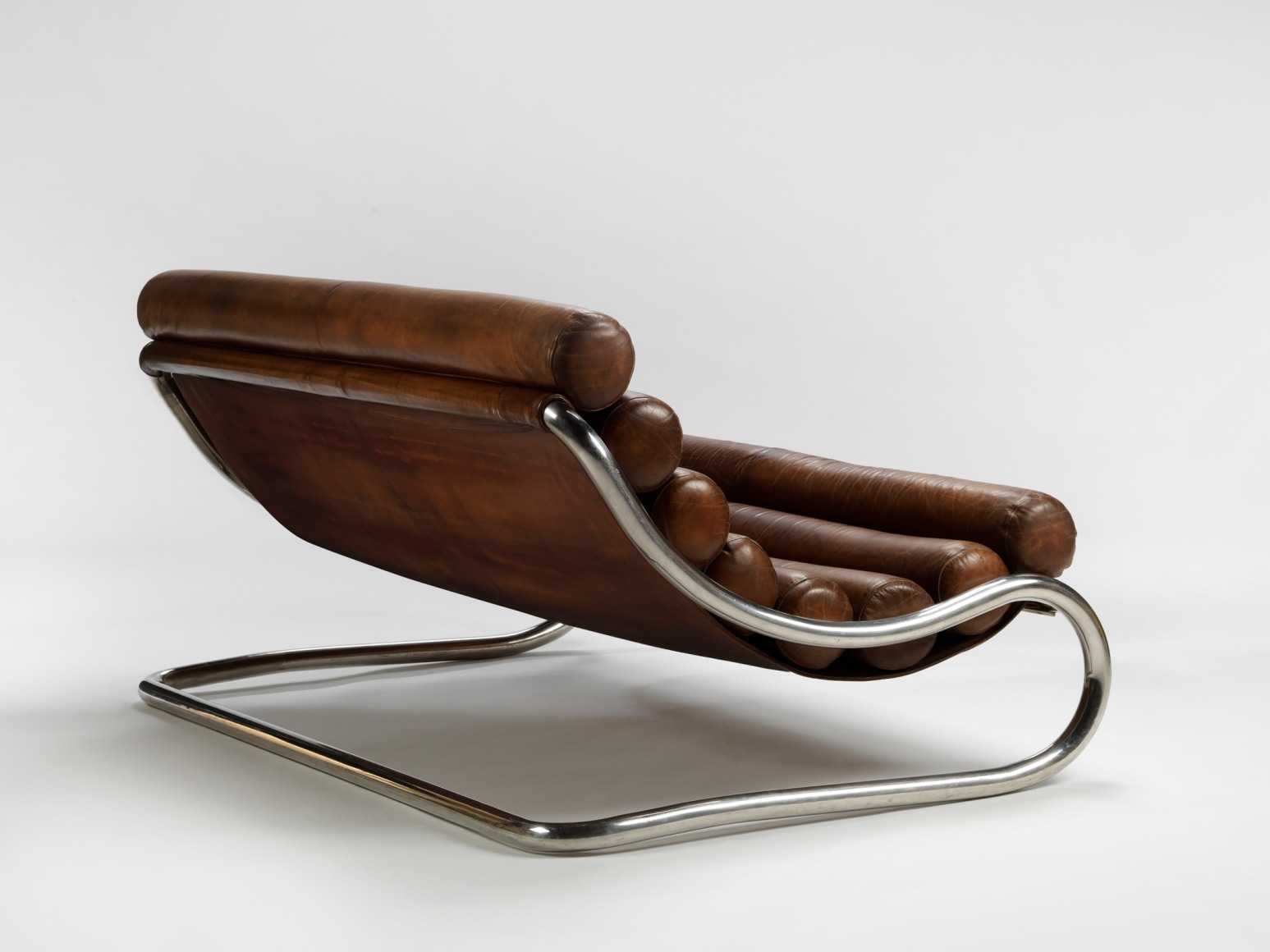 photograph of a leather chair in a blank room