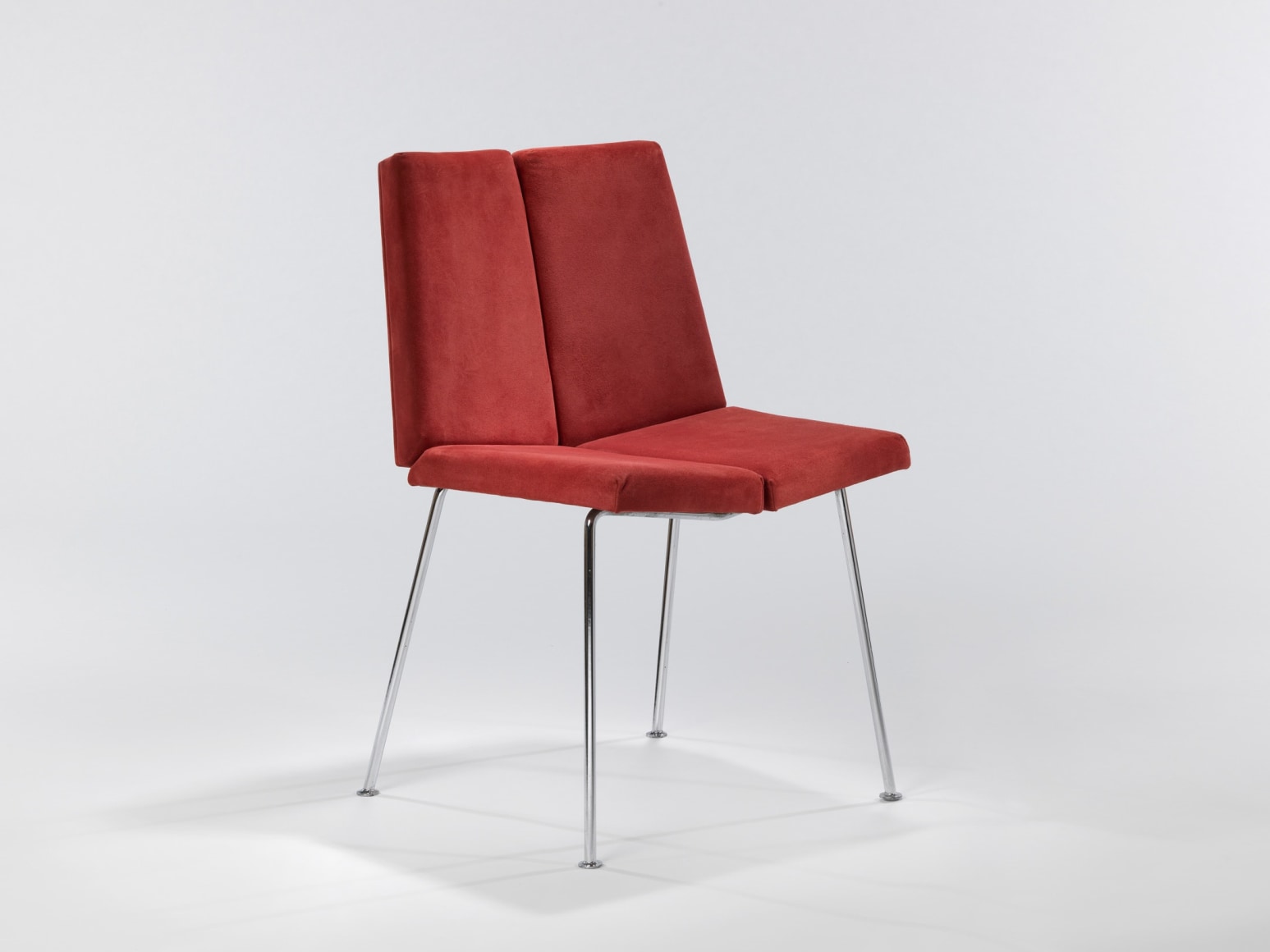 Single chair in red suede made by Pierre Guariche.