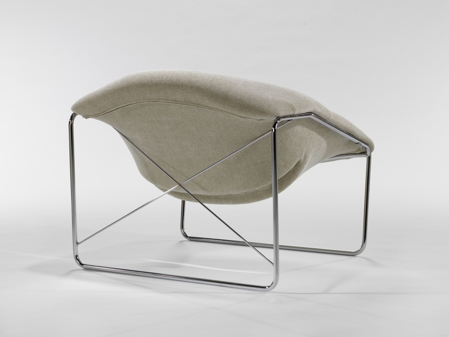 photograph of chair in a blank room with metal legs