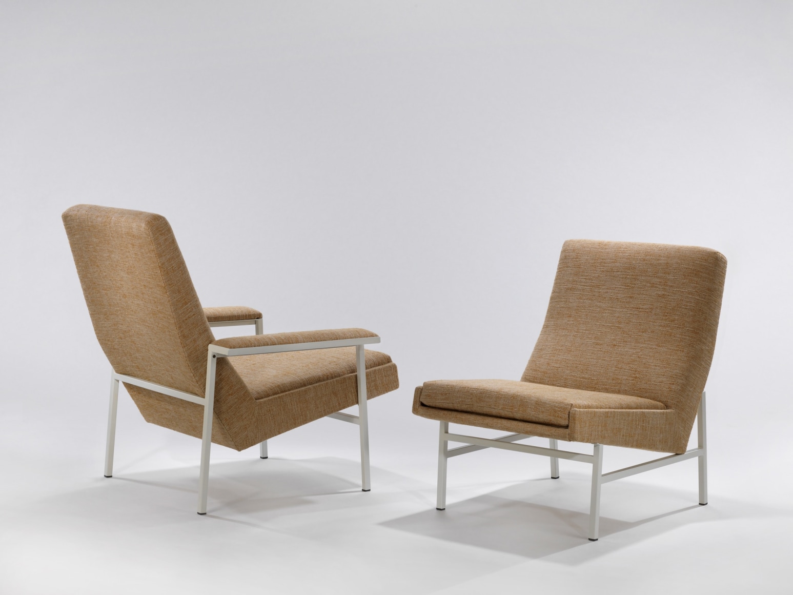 Pair of upholstered chairs, one with arms and one without, by A.R.P.