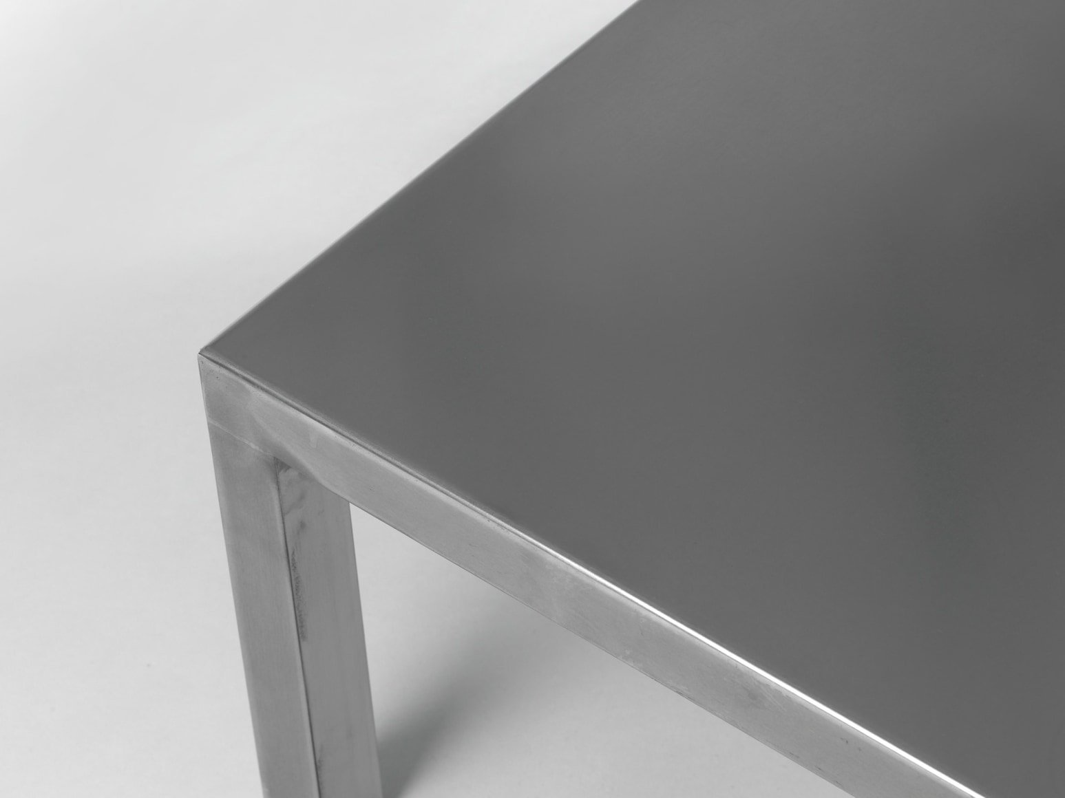 Stainless steel low table in front of white background