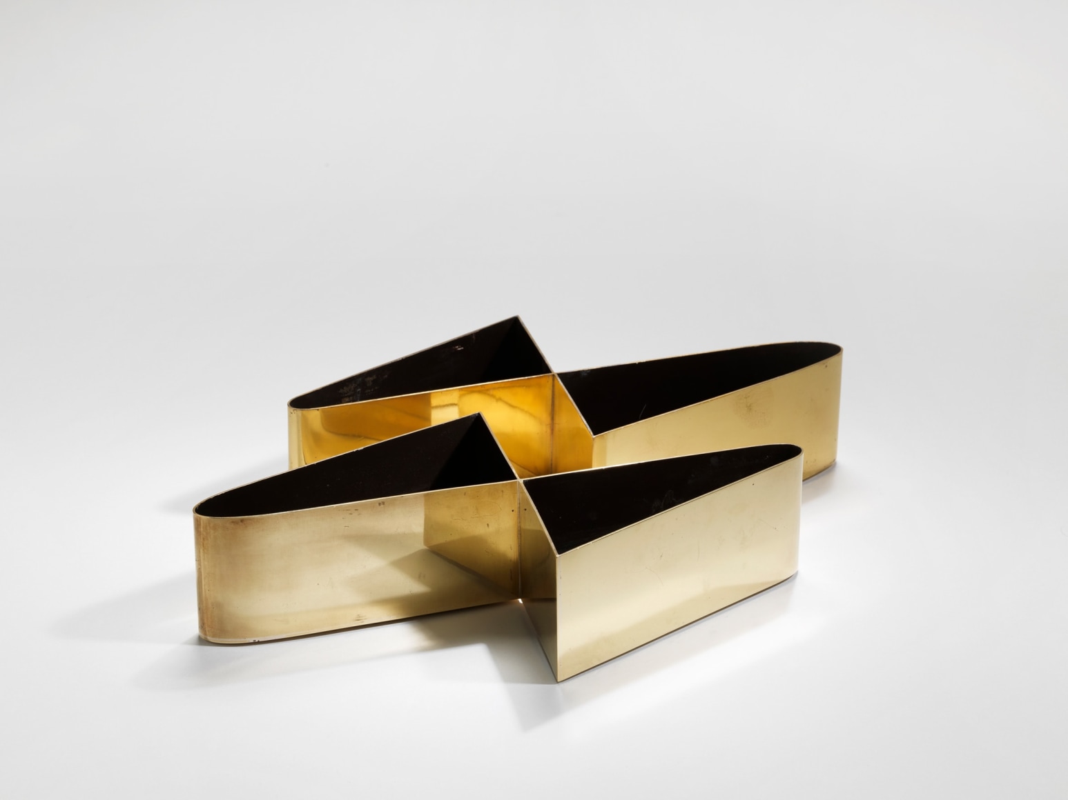 photograph of gold vases in a blank room