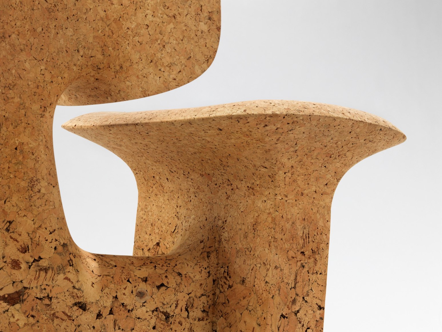 cork chair with great curves by made in situ. Image with grey background.
