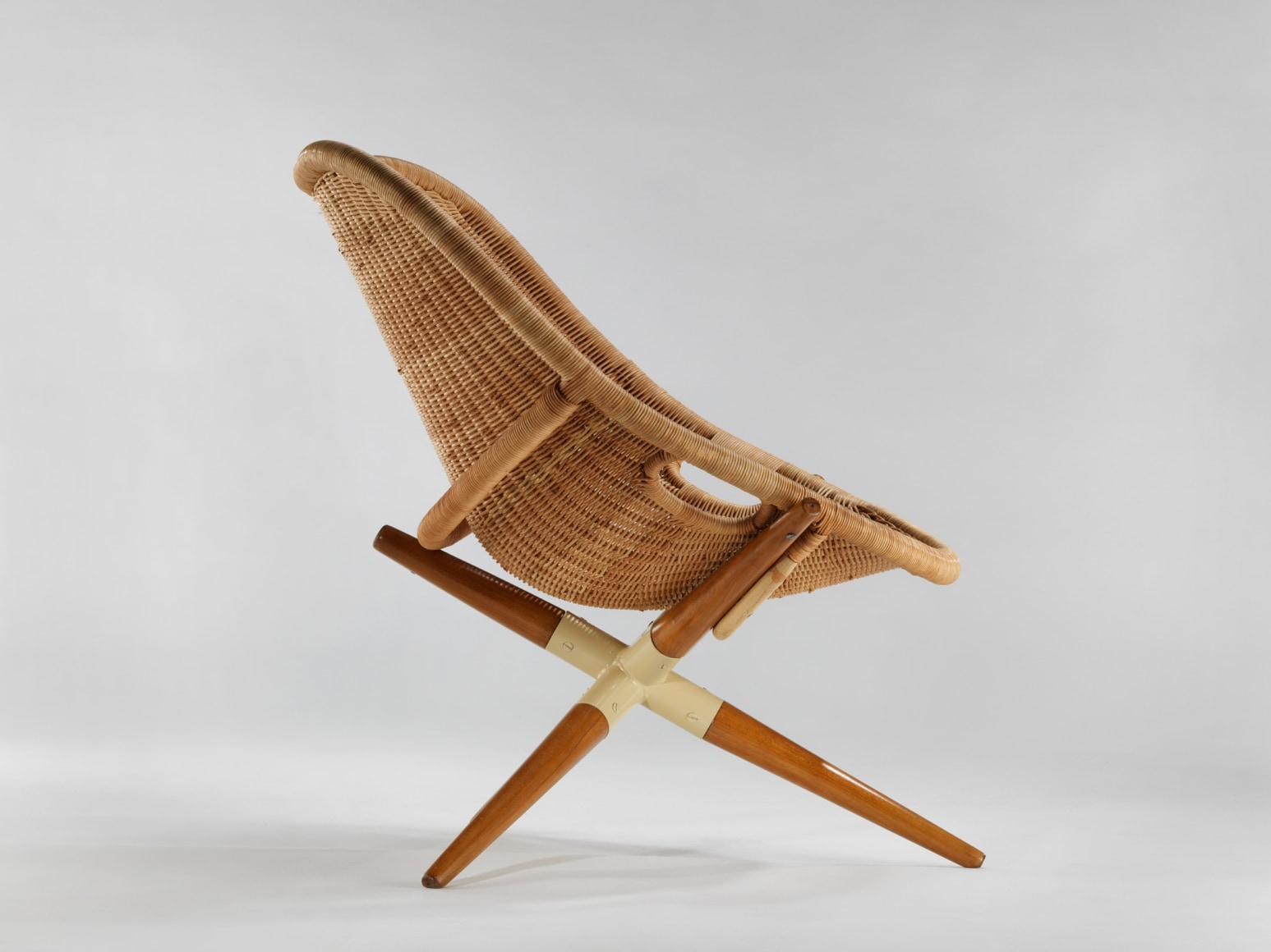 rattan chair in a blank room with tripod legs