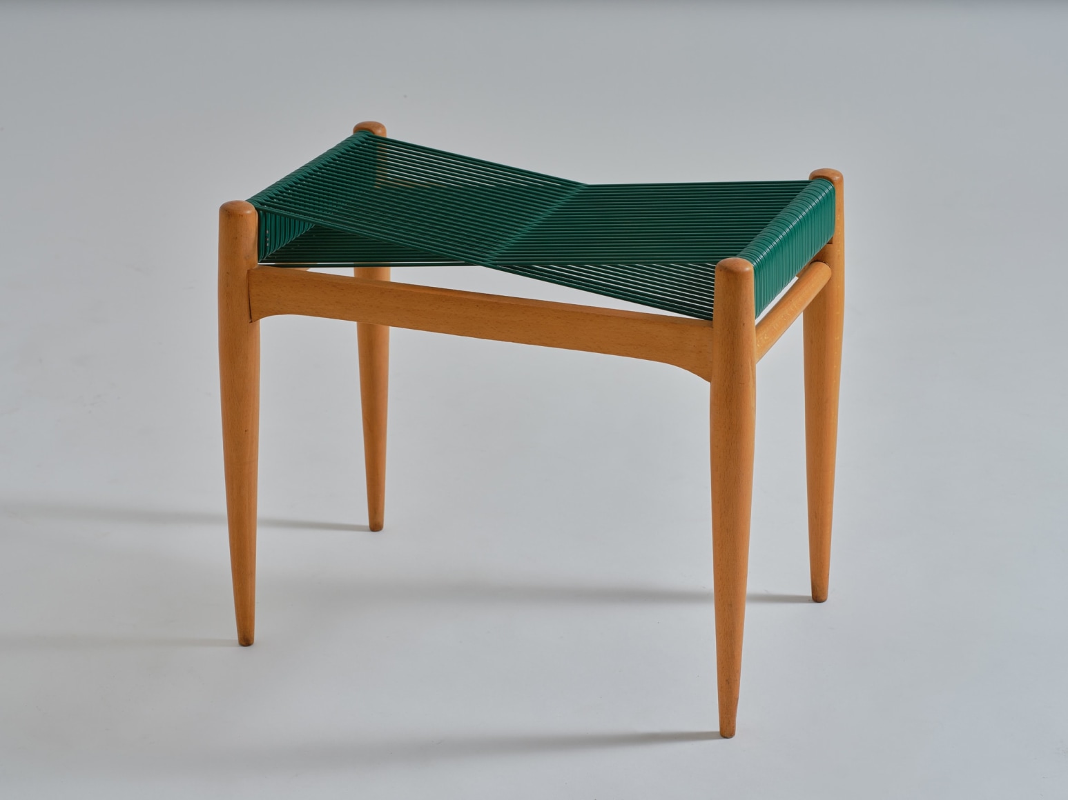 mcm stool in an empty room