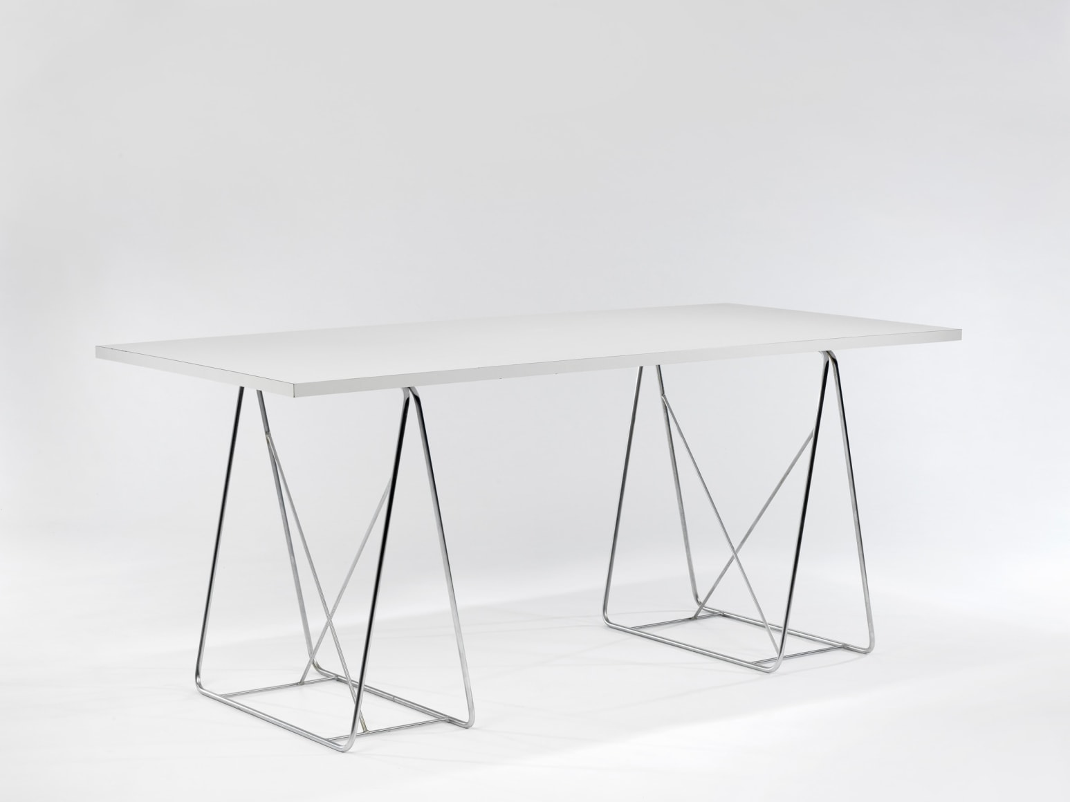 Formica and wood table with metal wire legs in front of white background
