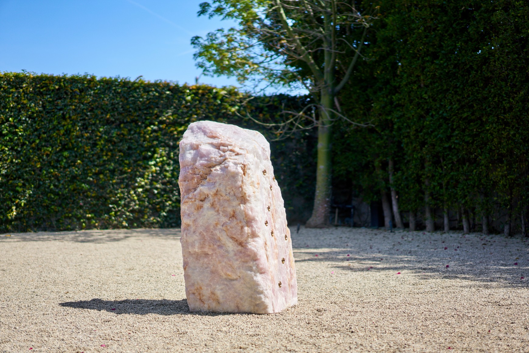 Installation view of Mika Tajima, Pranayama (Monolith, F, Rose Quartz), 2021, rock sculpture