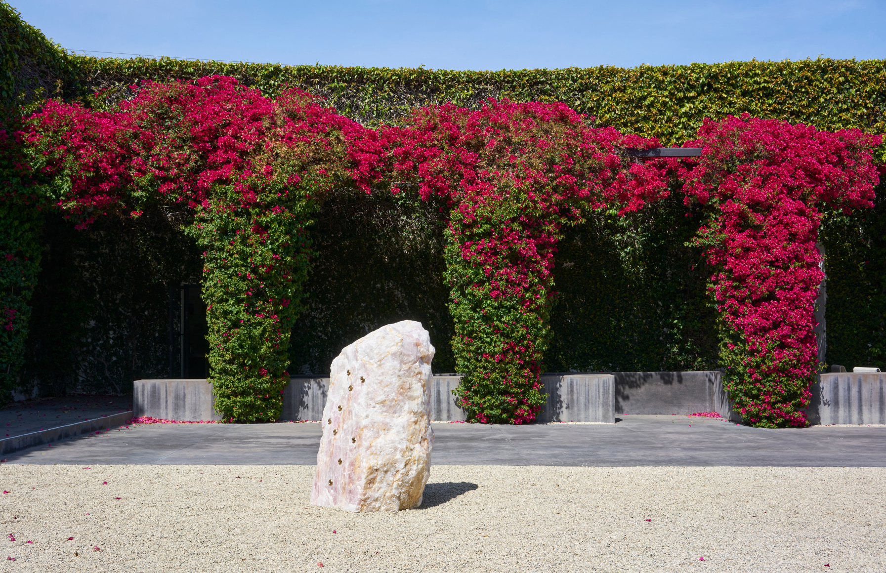 Installation view of Mika Tajima, Pranayama (Monolith, F, Rose Quartz), 2021, rock sculpture