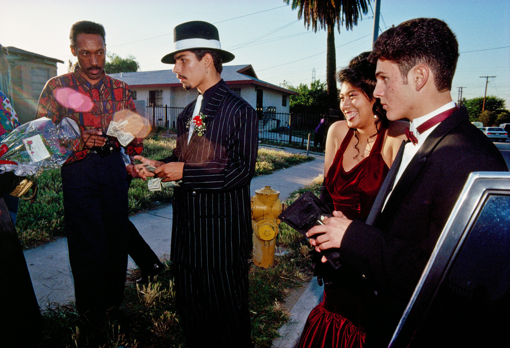 Enrique, 17, Hollywood High School senior-class president, pays for
a limousine outside his prom date’s home in South Central Los Angeles, 1993, Archival Pigment Print