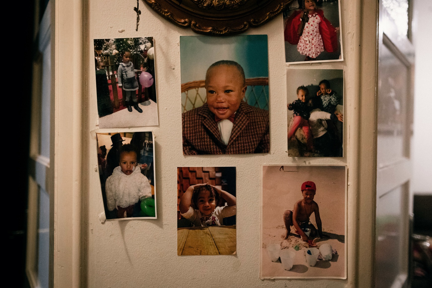 Photographs hanging on the walls of Ana Maria Jeremias' house in Rio de Mouro, showing her son, Luis, and her granddaughters, Beatriz and Leonor. Lisbon, Portugal, 2024