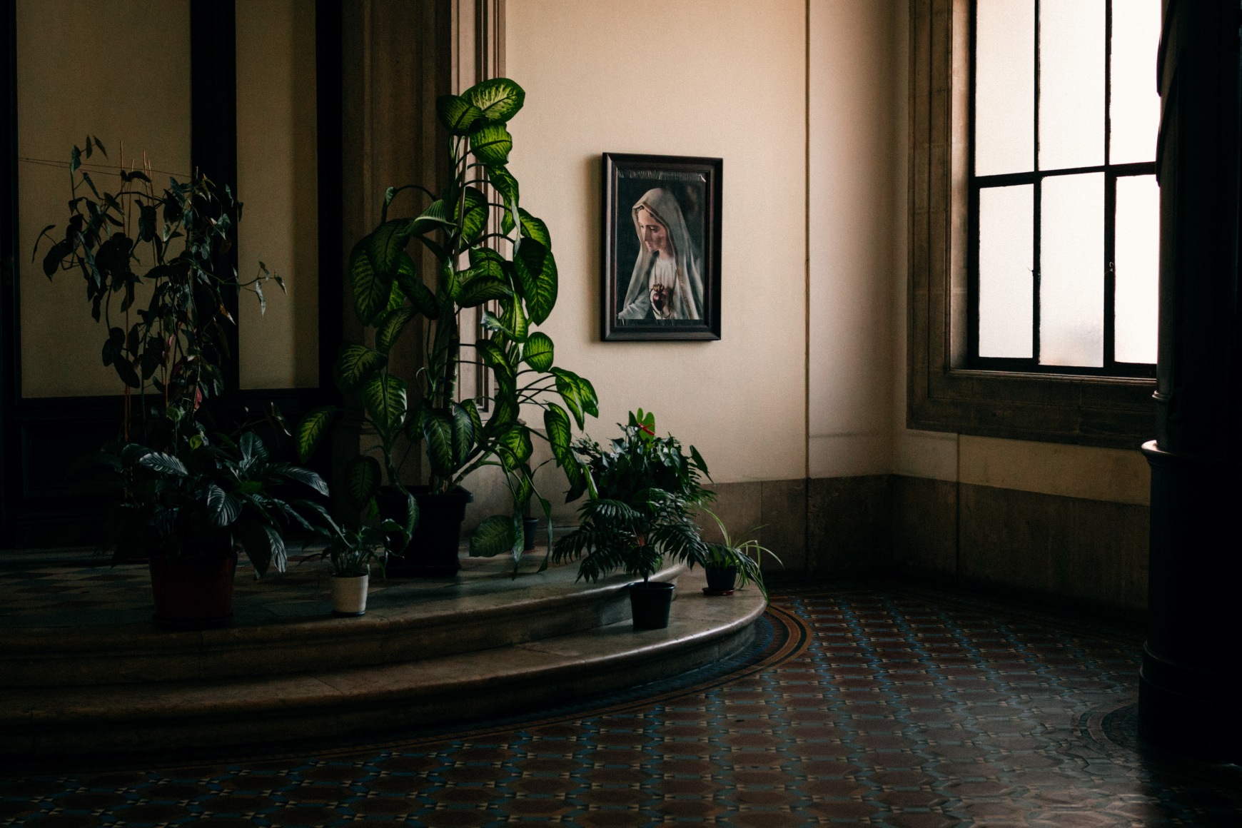The entrance hall of a church with a portrait of the Virgin Mary, where Ana Maria Jeremias prays on Wednesdays before going to work. Lisbon, Portugal, 2024