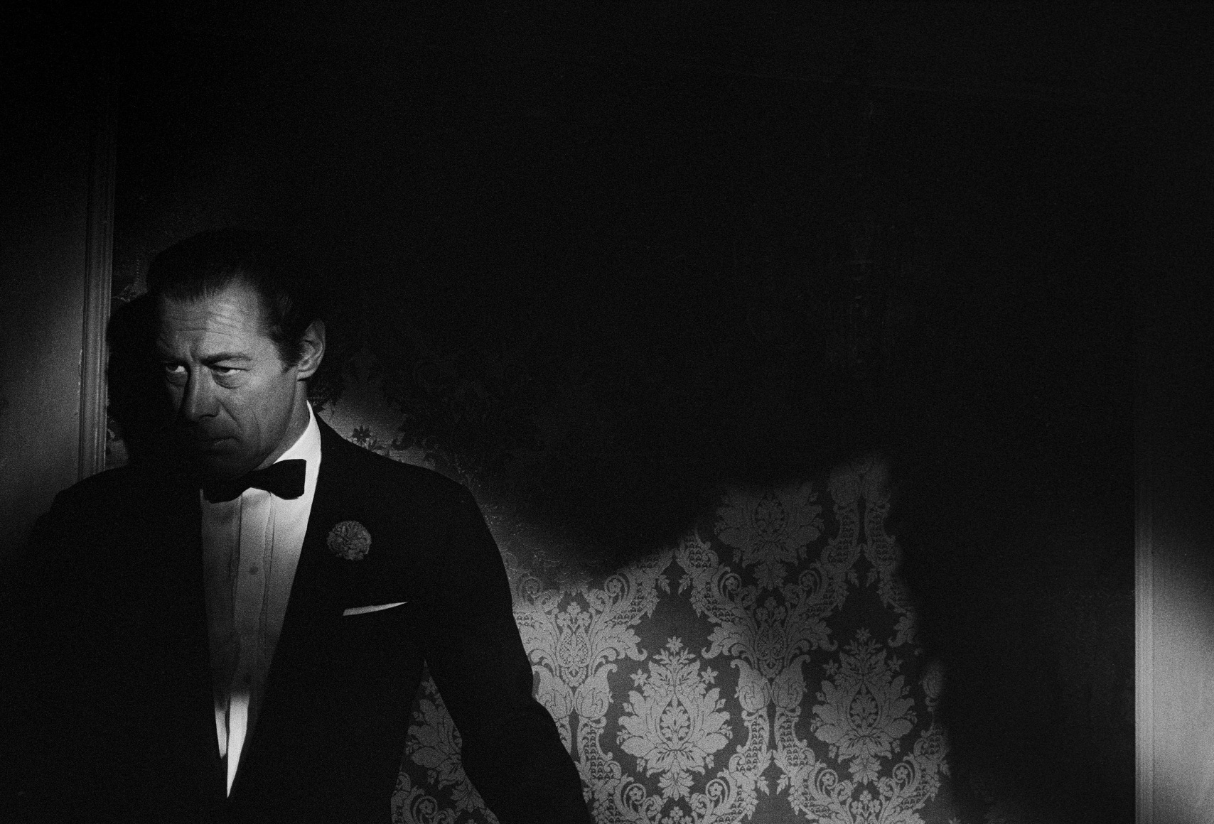 Rex Harrison peers ominously from the shadows on the set of "Midnight Lace", 1960, Archival Pigment Print