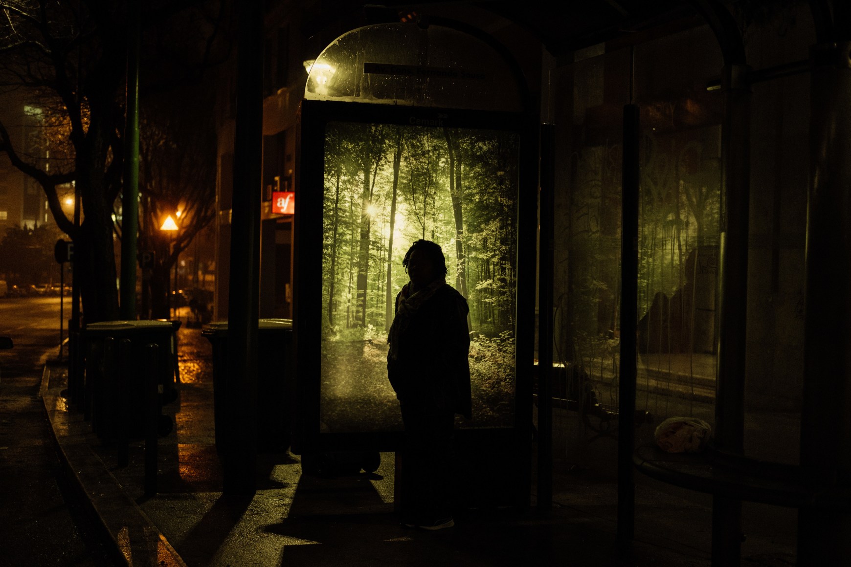 At dawn, Ana Maria Jeremias waits for the second bus in Campolide on her way to work, from the outskirts of Lisbon to the city center. She first has to catch a train, followed by two buses to reach her destination. Lisbon, Portugal, 2024
