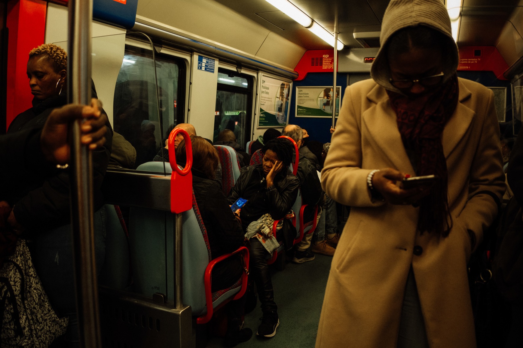 Ana Maria Jeremias commuting to work at dawn by train from the outskirts of Lisbon to the city center, where the early morning crowd consists mostly of women. Lisbon, Portugal, 2024
