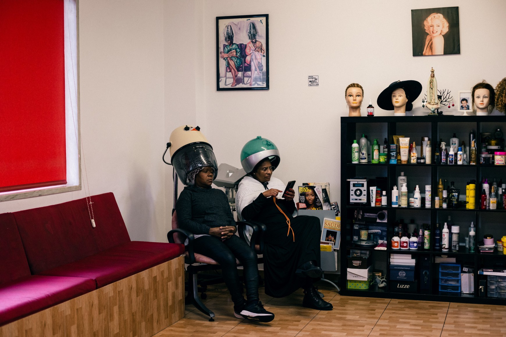 Ana Maria Jeremias at a friend's hairdressing salon, waiting to have her hair braided. Lisbon, Portugal, 2024