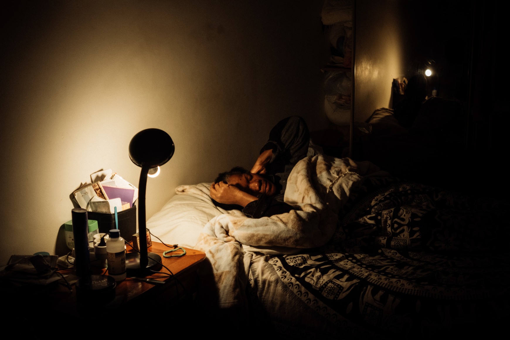 Ana Maria Jeremias at home, falling asleep as soon as she arrives, sleeping only about 4 hours per day. Lisbon, Portugal, 2024