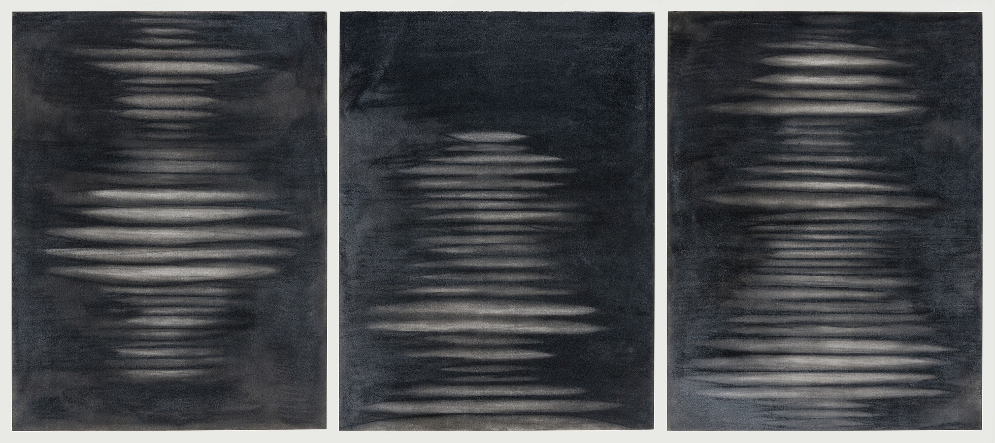 a triptych of abstract drawings by Elizabeth Turk of white discs stacked on each other