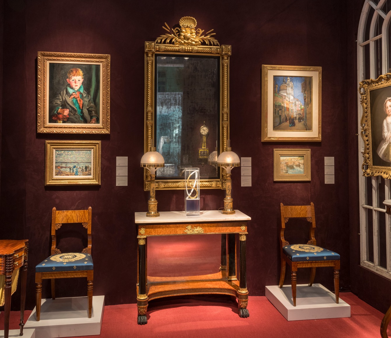 The Winter Show 2024, Hirschl &amp; Adler Galleries Booth B9, north room with works by Robert Henri, Maurice Prendergast, Jane Peterson, Childe Hassam, side chairs, and pier table by Charles-Honor&eacute; Lannuier.