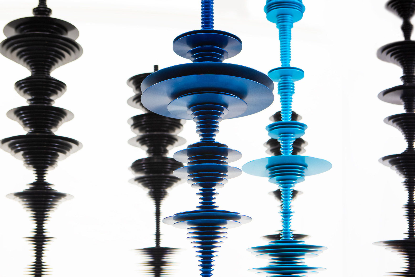 sculptures by Elizabeth Turk of colored aluminum discs layered and arranged to resemble Modernist abstractions and a sound waves