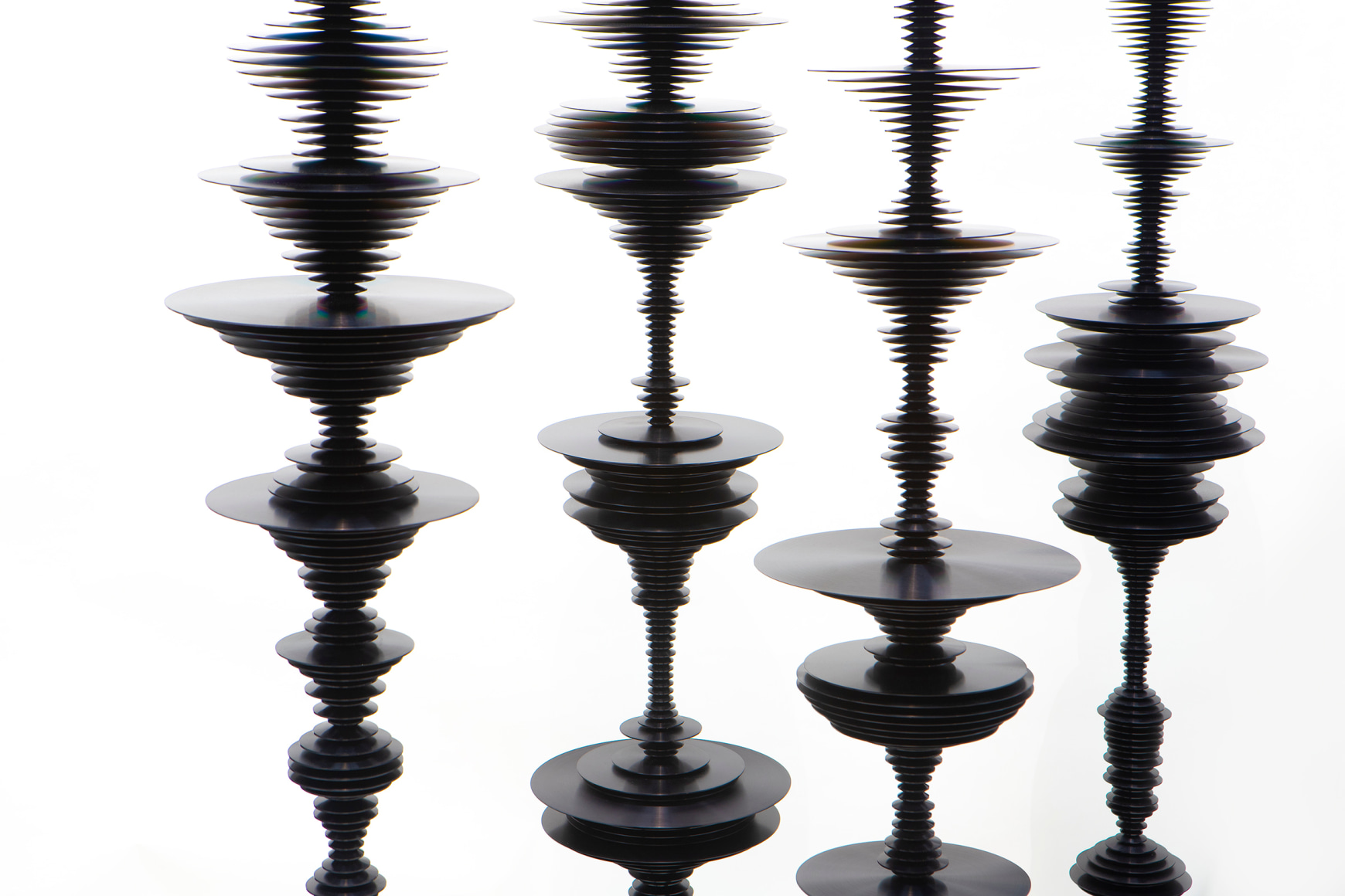 sculptures by Elizabeth Turk of black aluminum discs layered and arranged to resemble Modernist abstractions and a sound waves