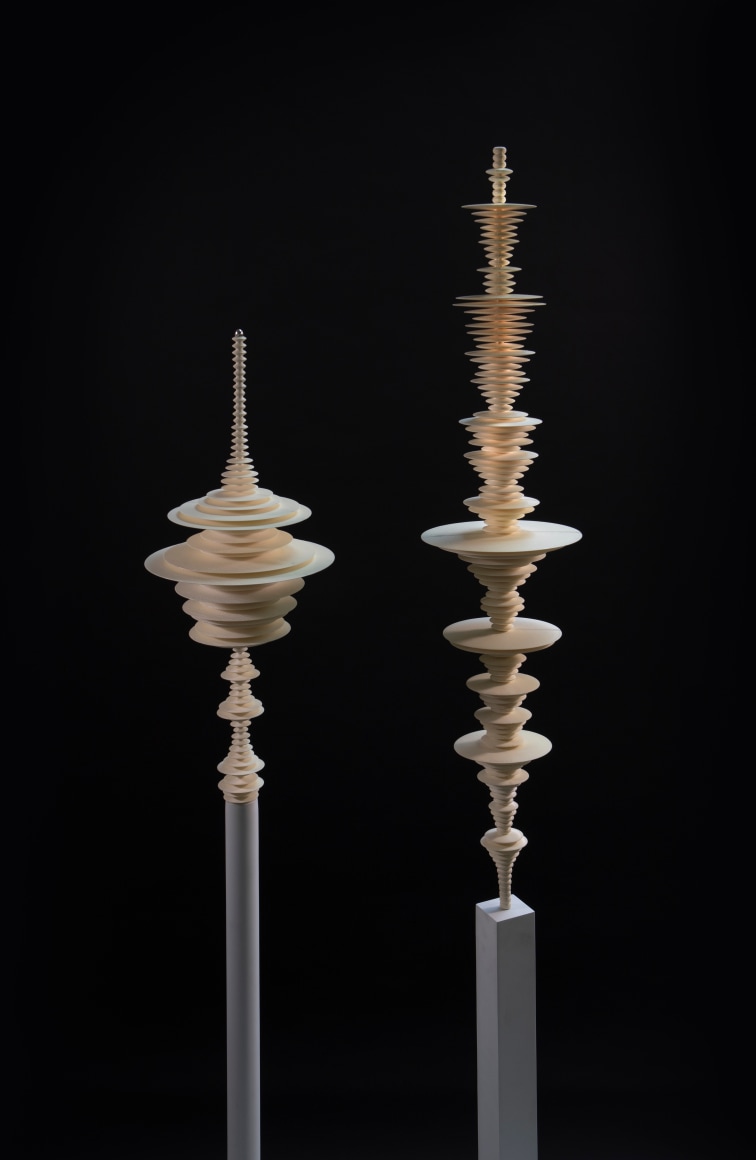 sculptures by Elizabeth Turk of 3D-printed discs layered and arranged to resemble Modernist abstractions and a sound waves