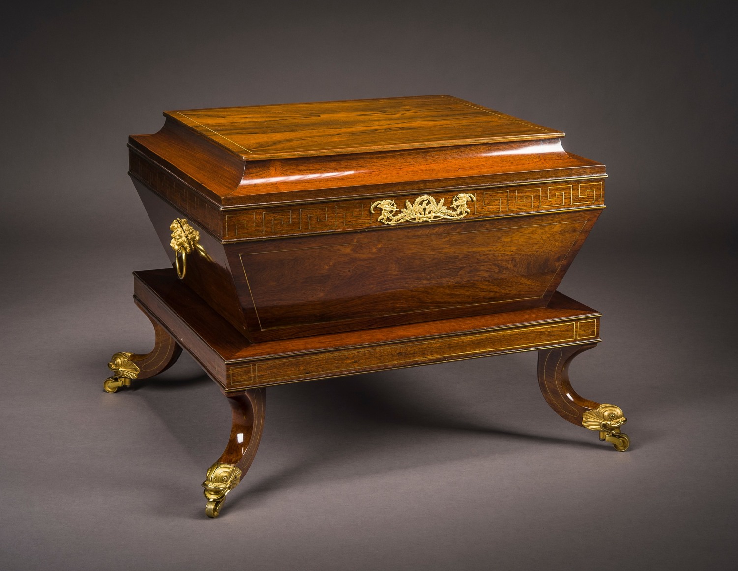 Attributed to Thomas Seymour (1771&ndash;1848), Boston. &quot;Wine Cooler,&quot; about 1815. Rosewood and mahogany (secondary woods: mahogany, rosewood, and white pine), with brass line inlay, gilt-brass dolphin toe caps and castors and lion-head handles, ormolu mount, and zinc liner, 25 1/2 in. high, 36 1/8 in. wide, 30 in. deep