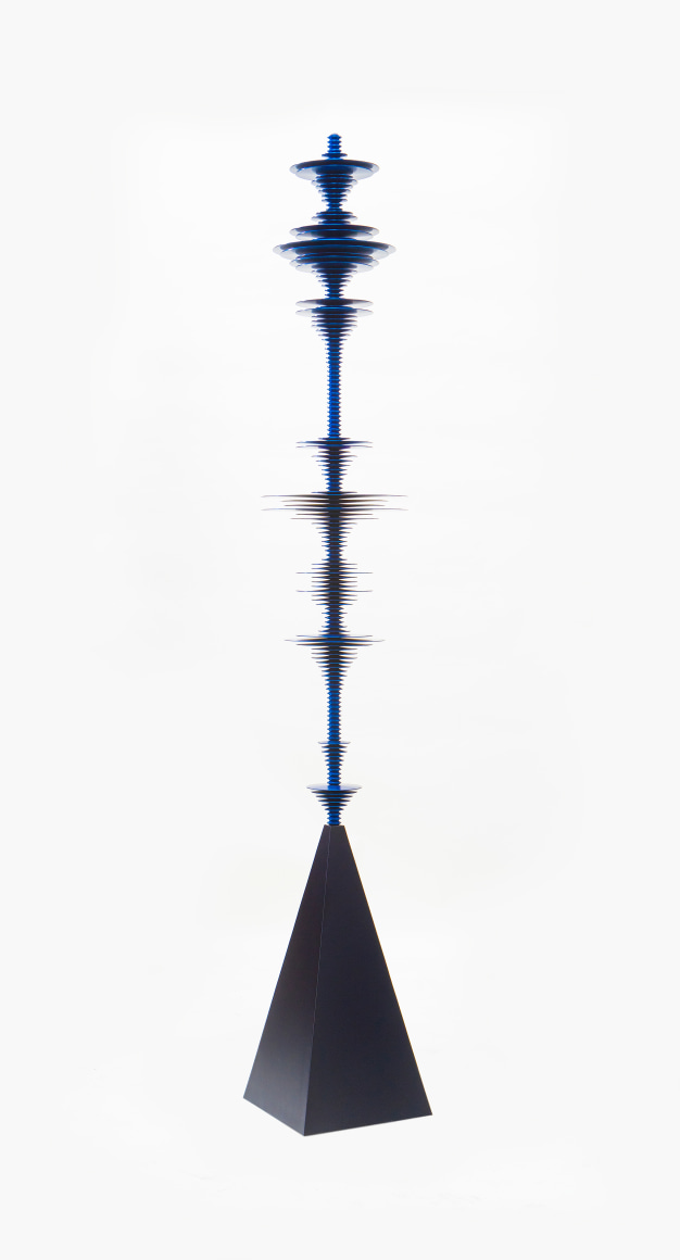 a sculpture by Elizabeth Turk of dark blue aluminum discs layered and arranged to resemble a sound wave and a modernist abstraction