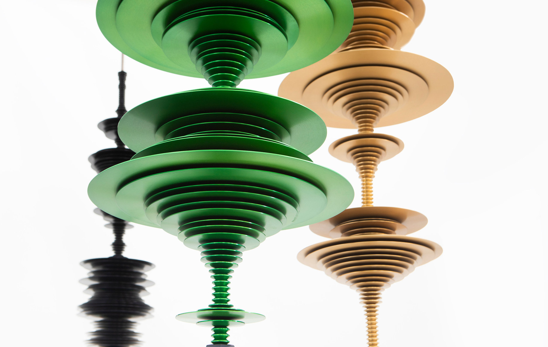 sculptures by Elizabeth Turk of colored aluminum discs layered and arranged to resemble Modernist abstractions and a sound waves