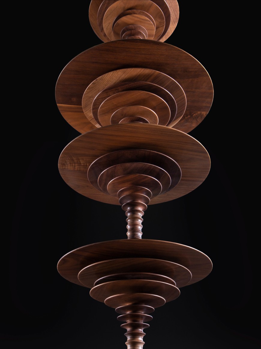 a sculpture by Elizabeth Turk of wood discs layered and arranged to resemble a Modernist abstraction and a sound wave