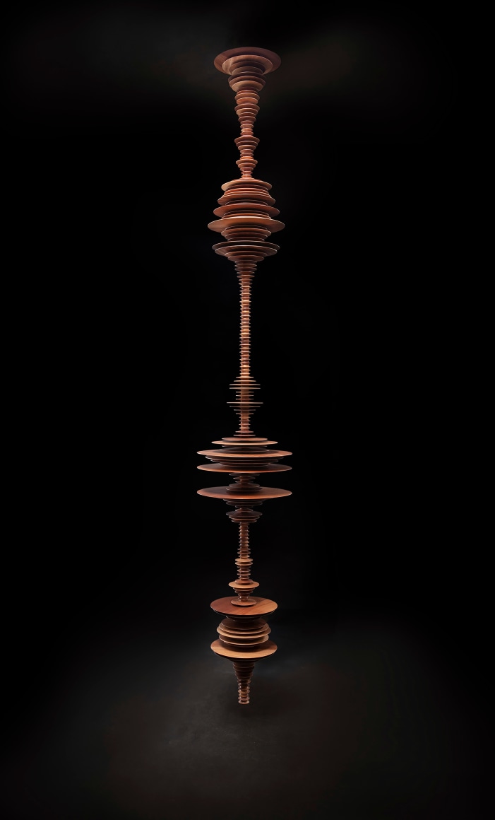 a sculpture by Elizabeth Turk of wood discs layered and arranged to resemble a sound wave and a modernist abstraction