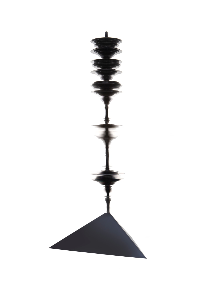 a sculpture by Elizabeth Turk of black aluminum discs layered and arranged to resemble a sound wave and a modernist abstraction