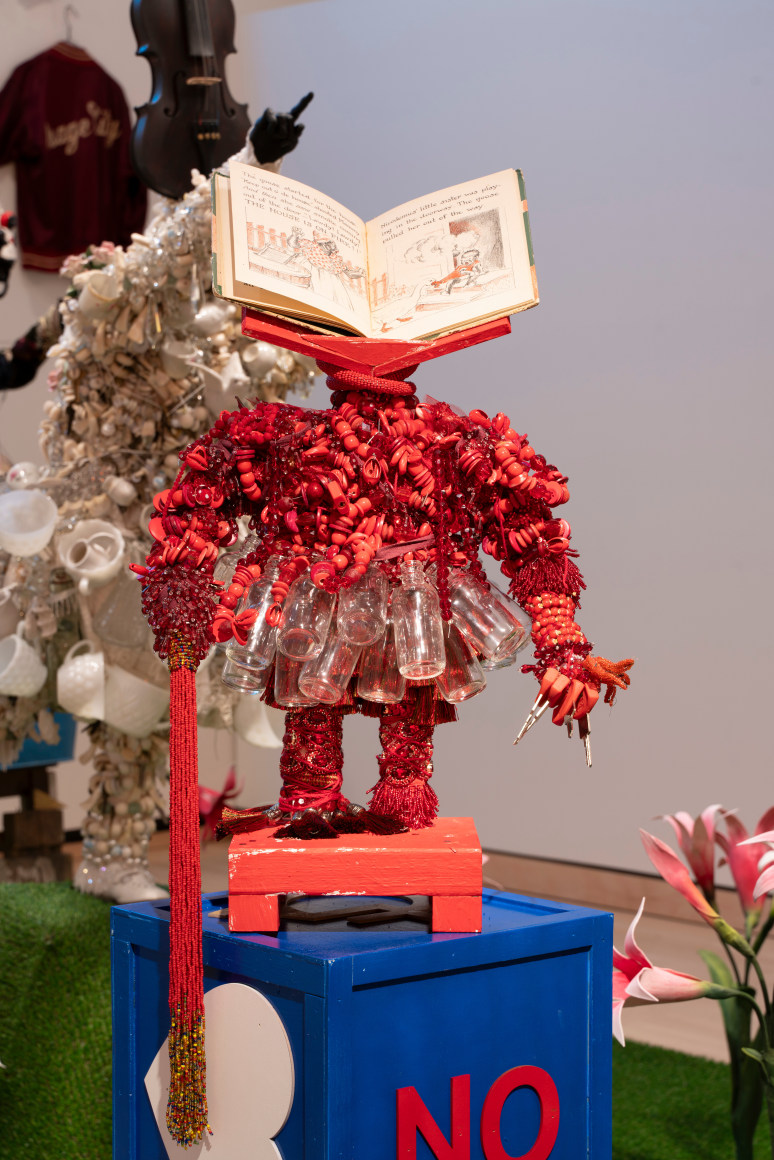 Red Power sculpture with a children's book as a head