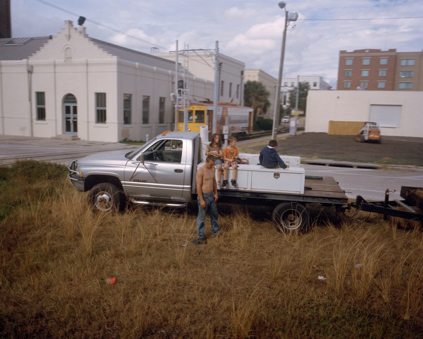 Landscape with people and truck from train window, by McNair Evans
