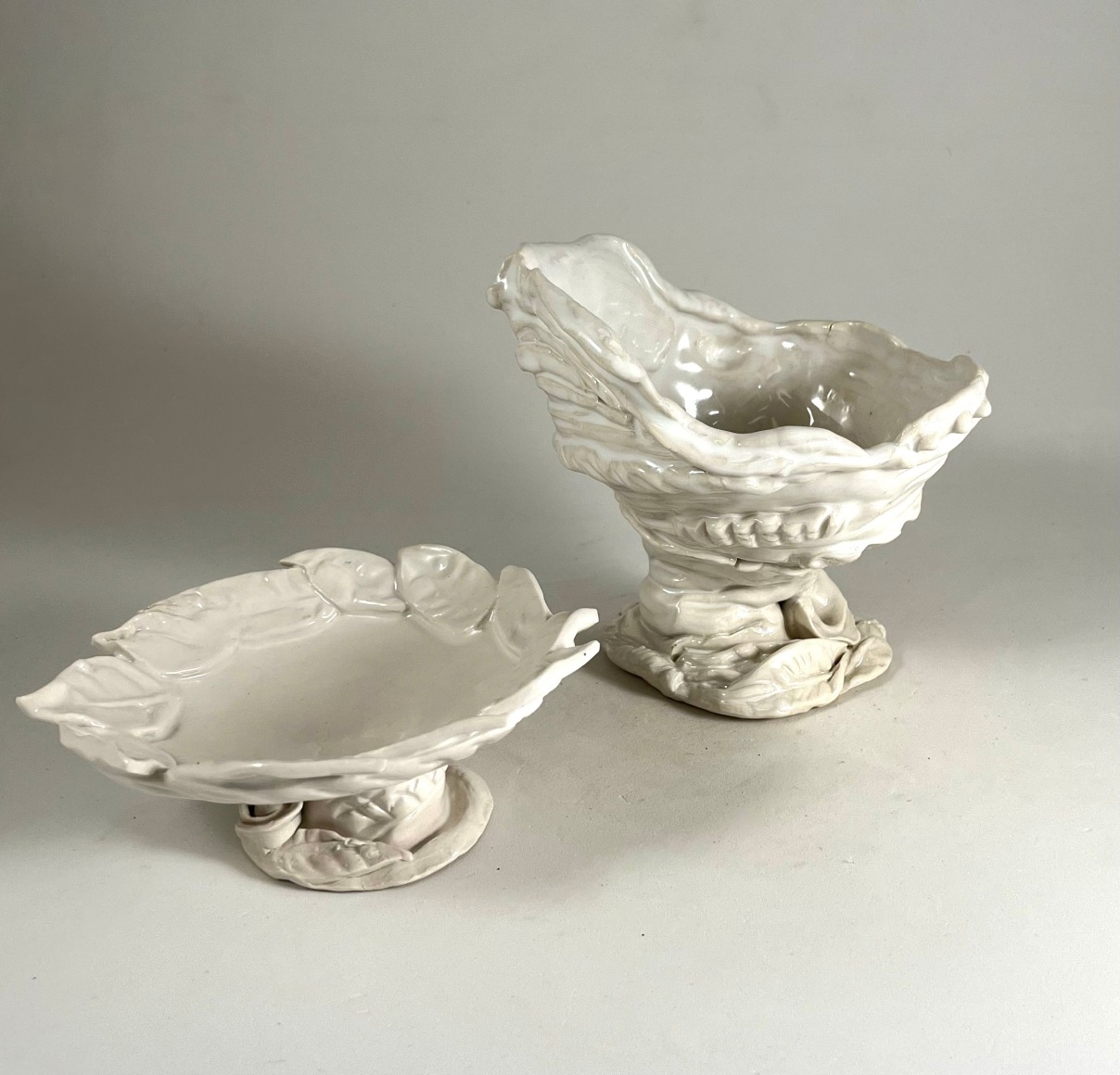 A  set white glazed porcelain objects a water bowl with leaves and flora as well as an ink palette with the same motif