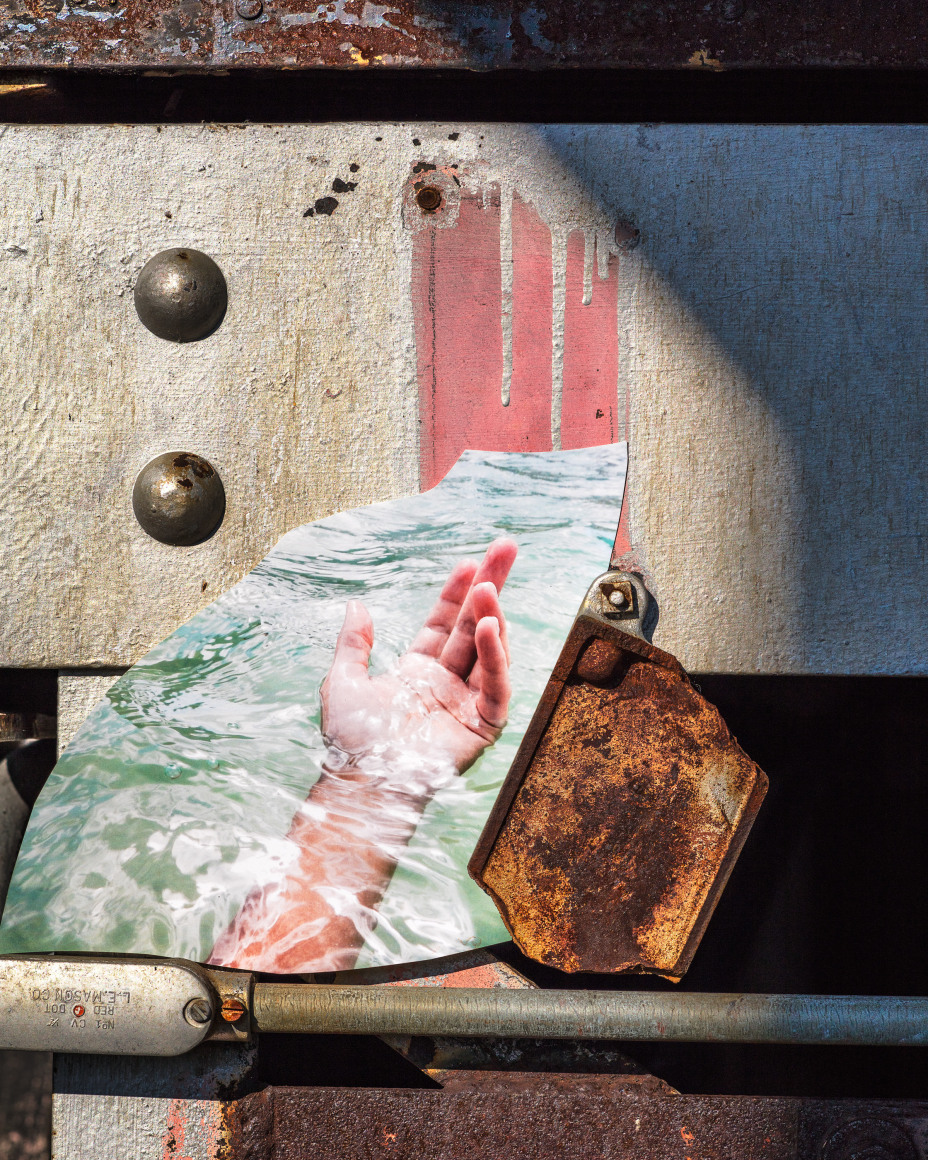 Hand, 2017 from the series FloodZone  Archival pigment print  16 x 20 inches, Edition of 5  32 x 40 inches, Edition of 5  40 x 50 inches, Edition of 5, image of a hand rising from the water, propped up on a rusted scaffolding against a concrete beam