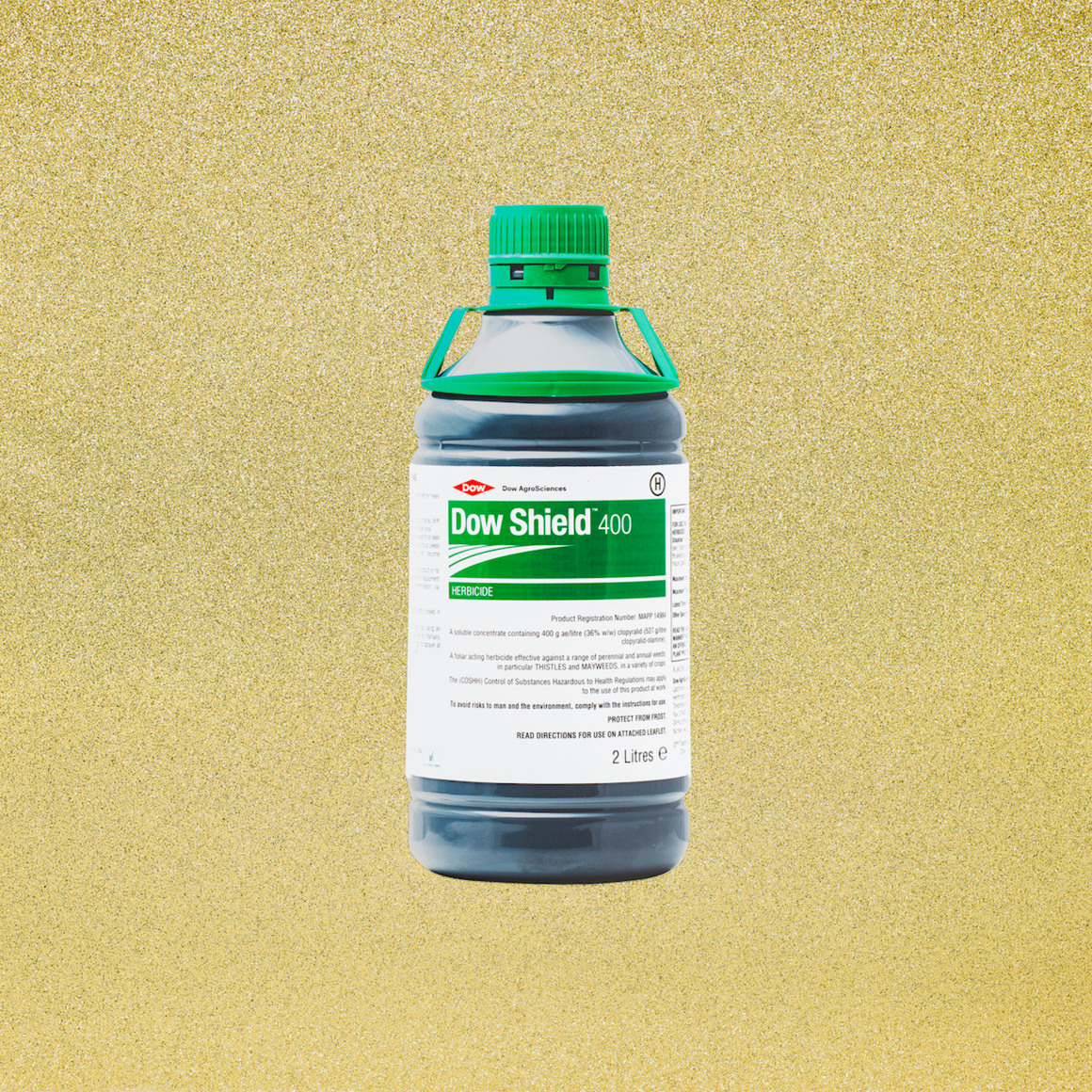 Dow Shield, 2022  Archival pigment print mounted to dibond  44 x 44 inches  Edition of 1, Bottle of Dow Shield on a golden glitter background