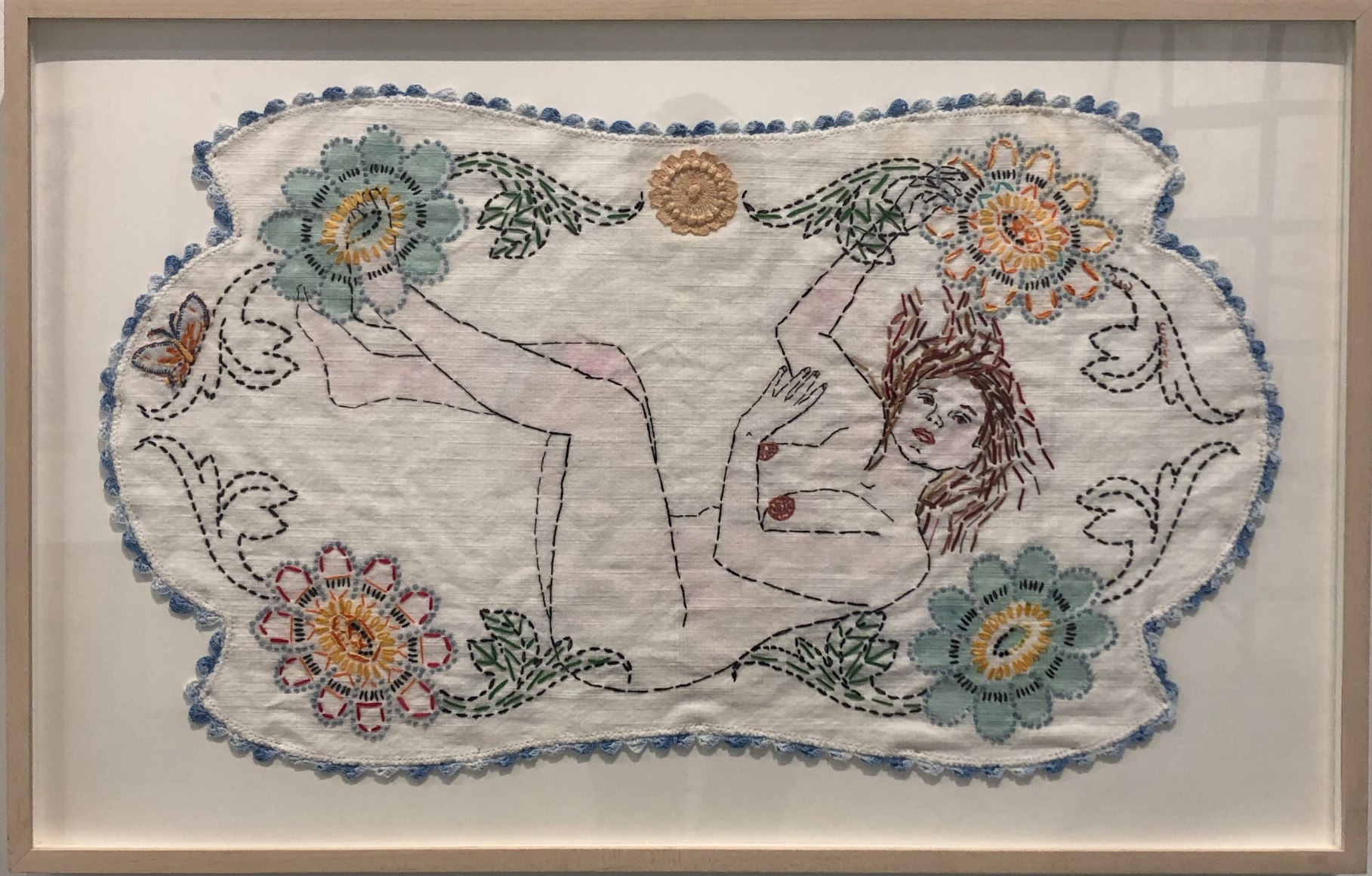 Image of a nude woman falling surrounded by a border of colorful flowers
