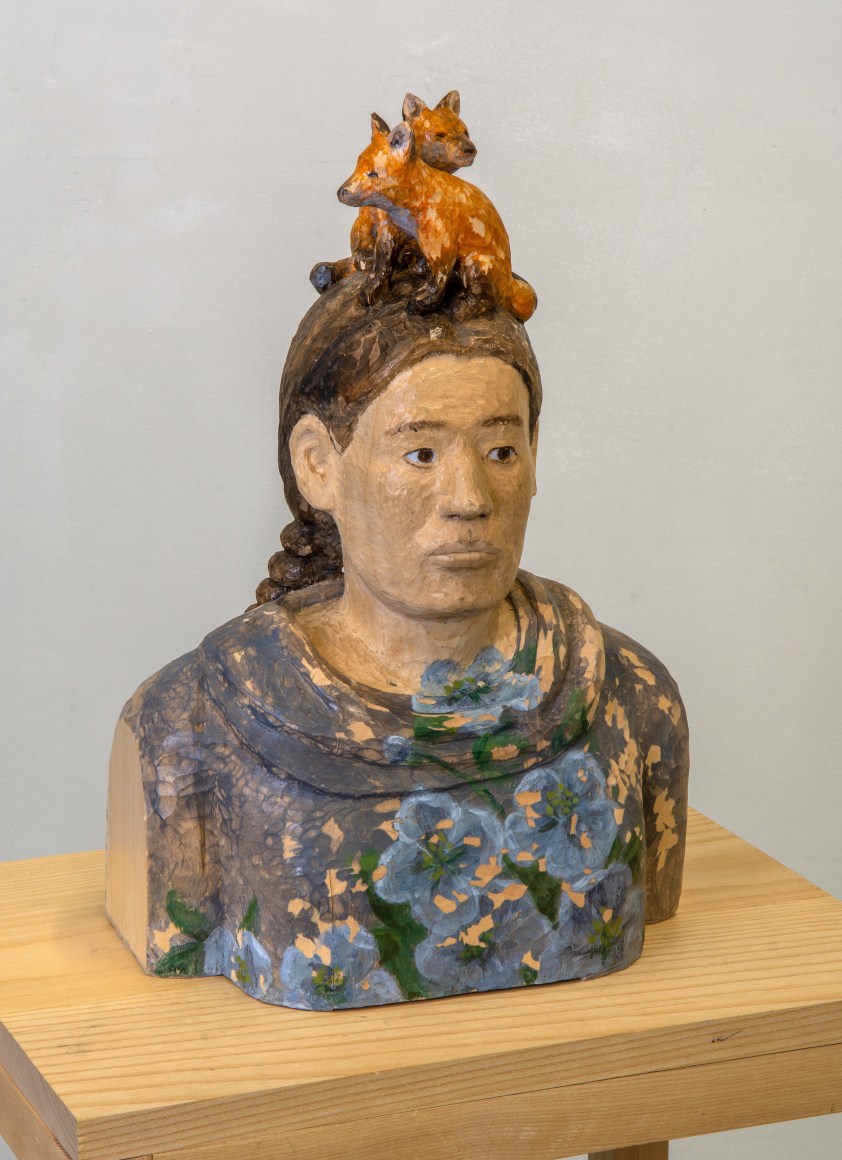 Bust wood sculpture with two small foxes on head, by Sachiko Akiyama