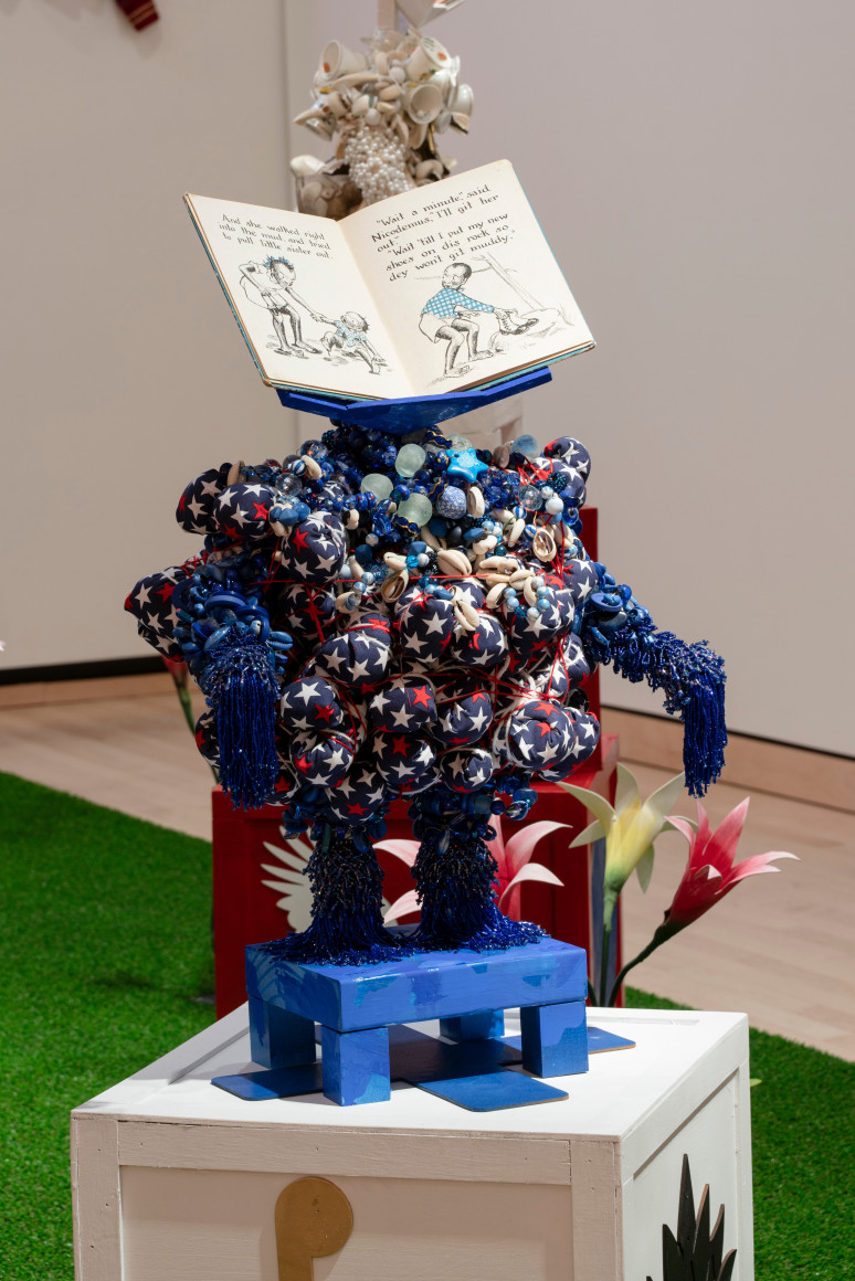 Blue Power sculpture with a children's book as a head