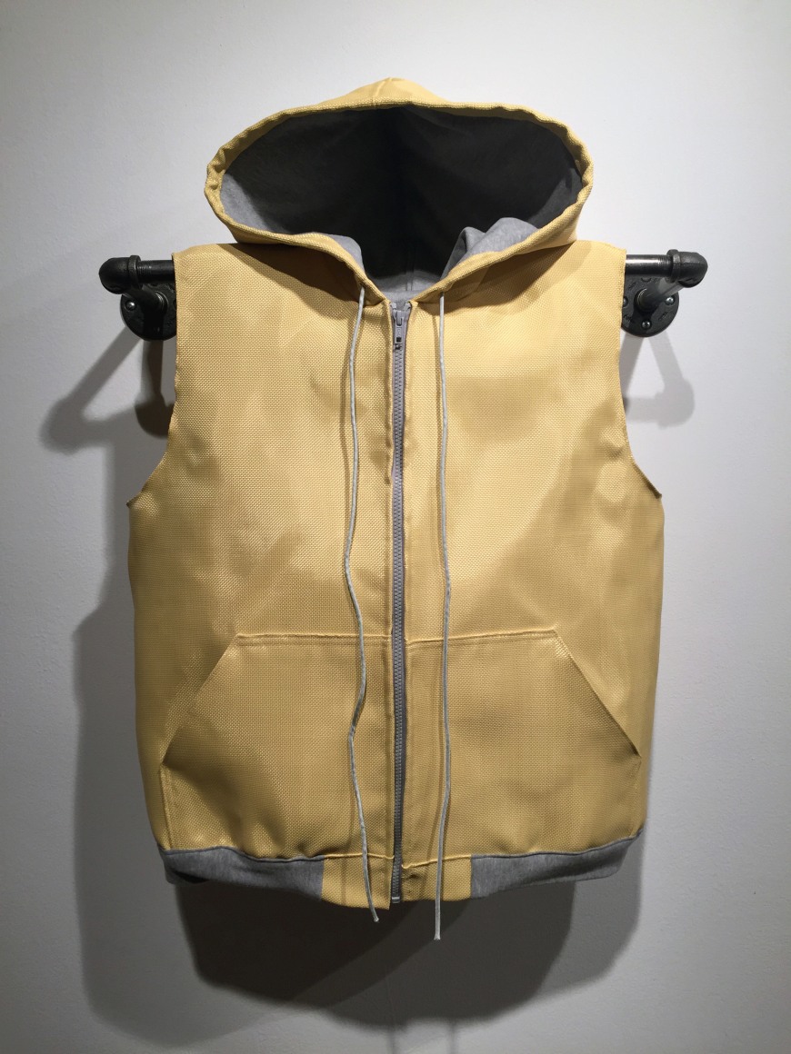 Yellow, sleeveless hoodie and vest. This vest is tailor-made to fit and protect Justin, Clinical Research Project Manager