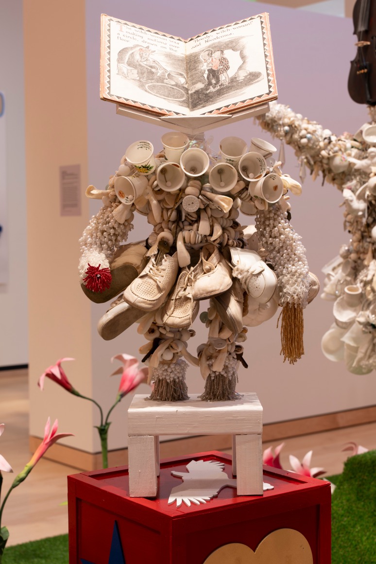 White Power sculpture with a children's book as a head