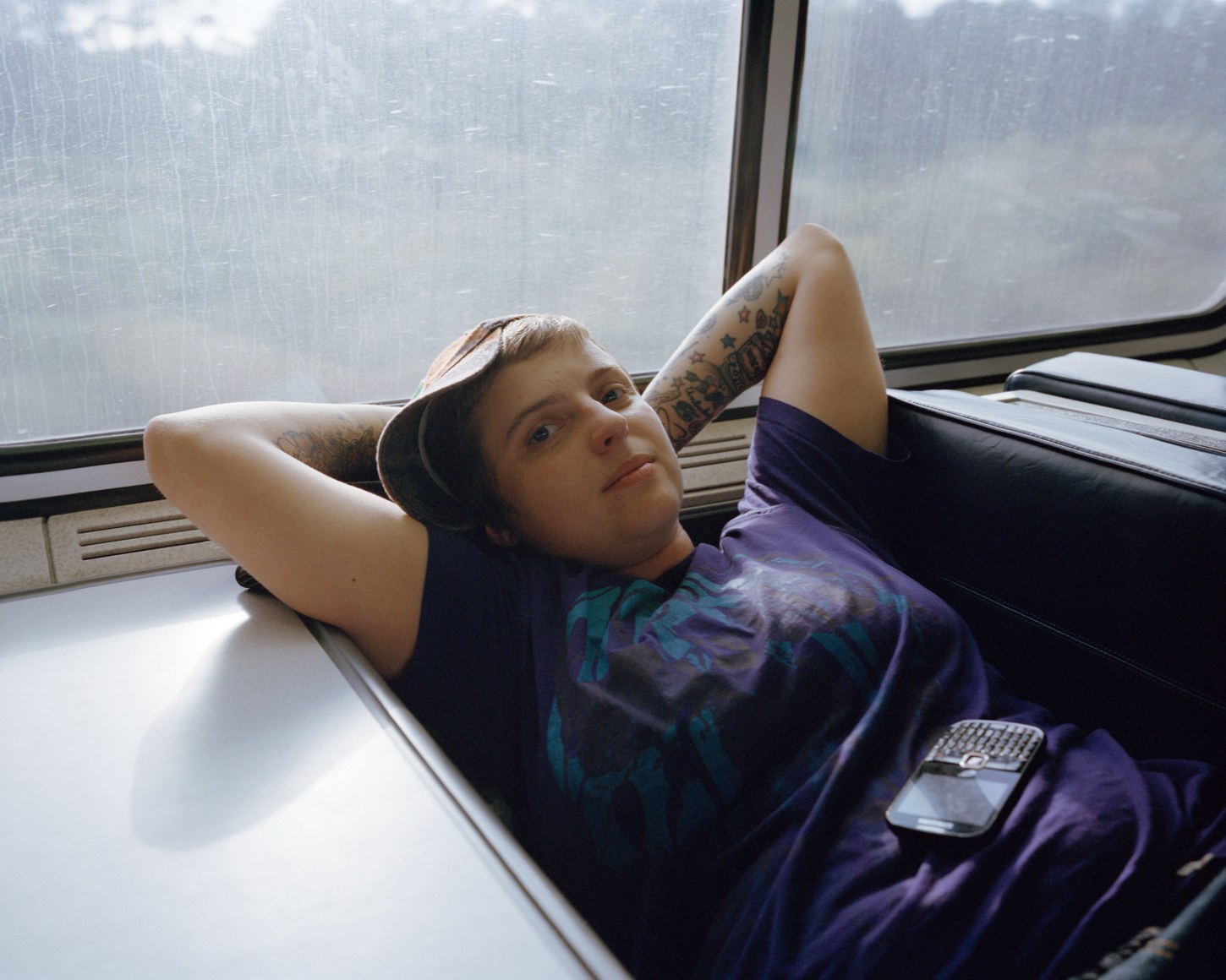 Person reclining on train booth