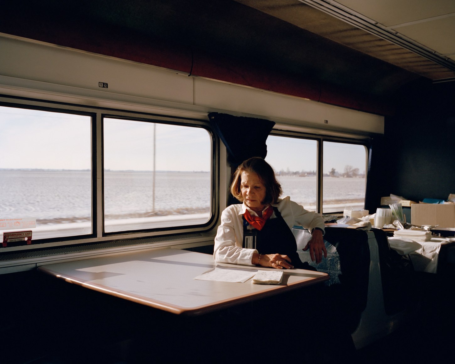 Amtrak worker at table on train