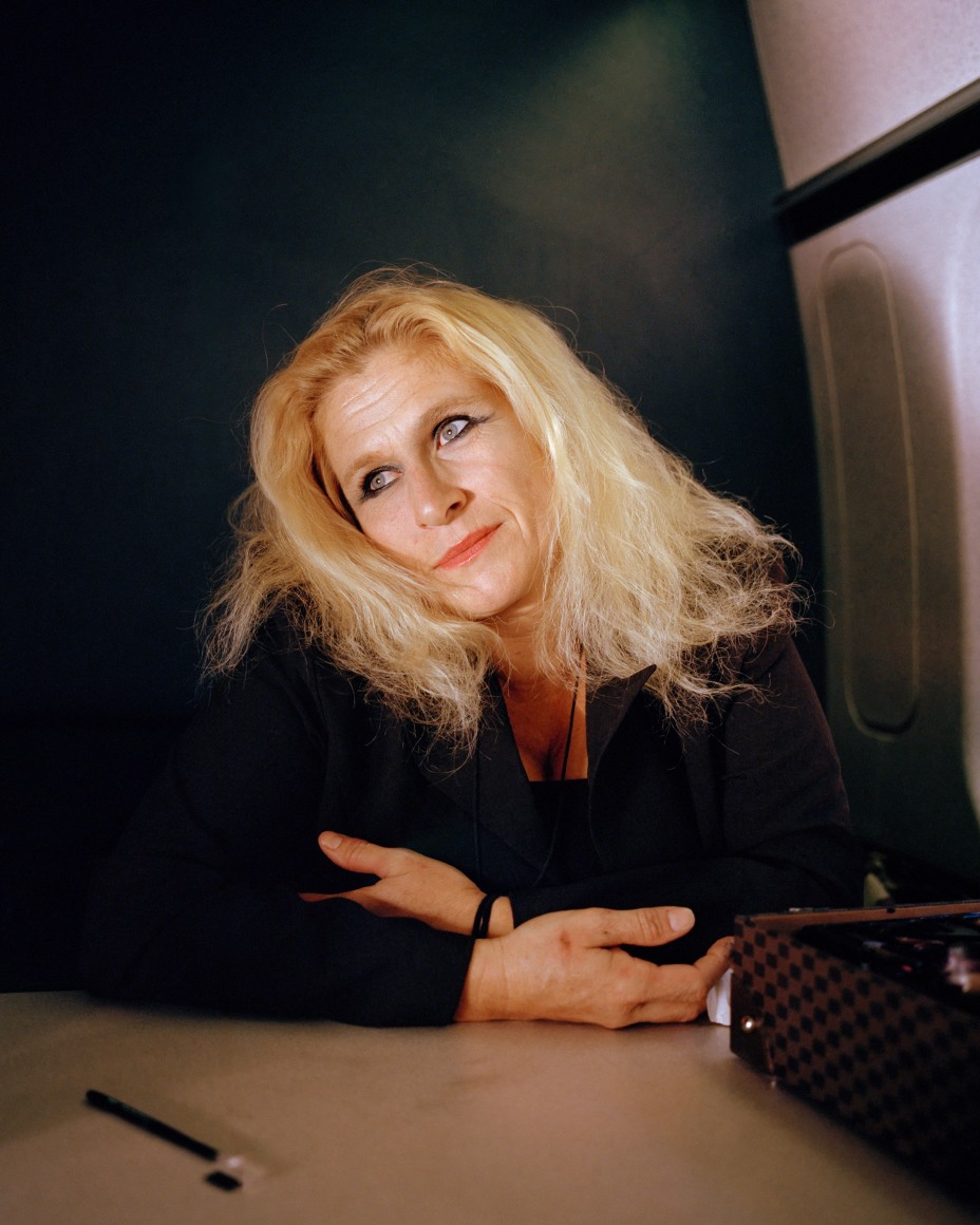 Torso of Person with big blonde hair on train, my McNair Evans