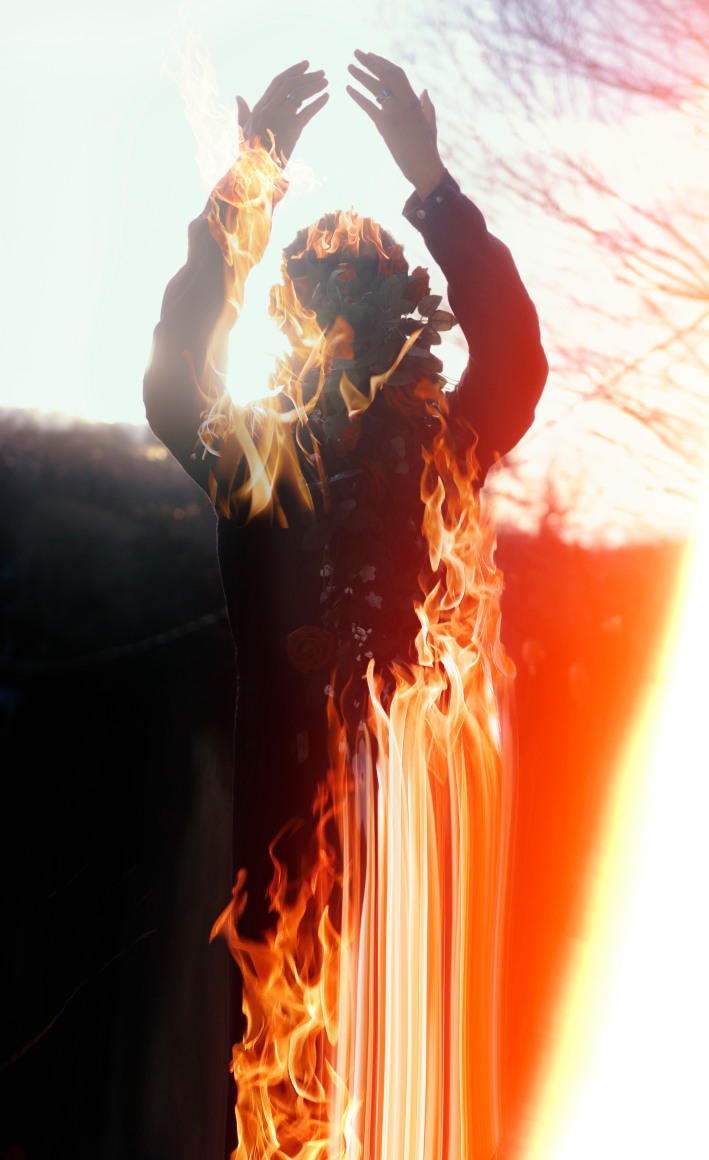 Portrait of the artist in shadow behind a bonfire