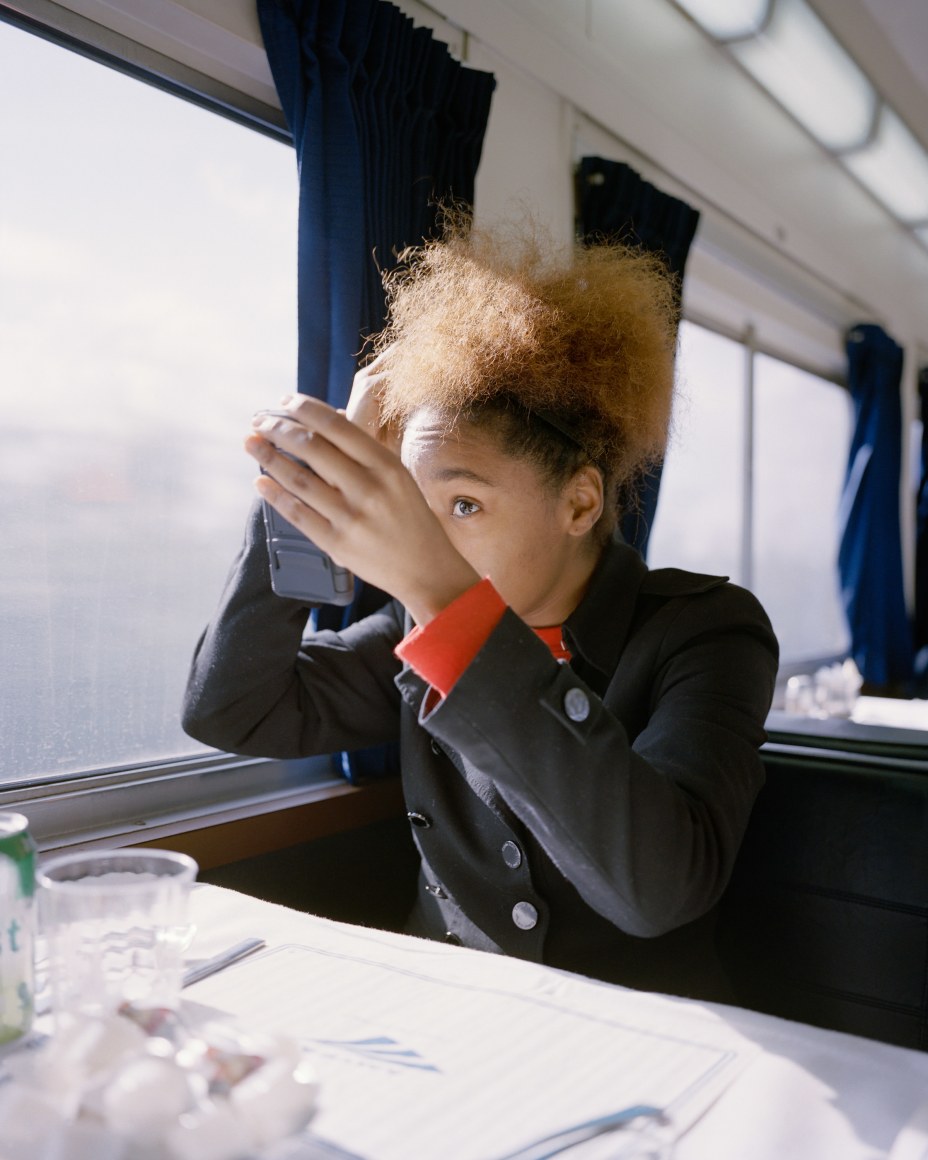 Person on train fixing hair