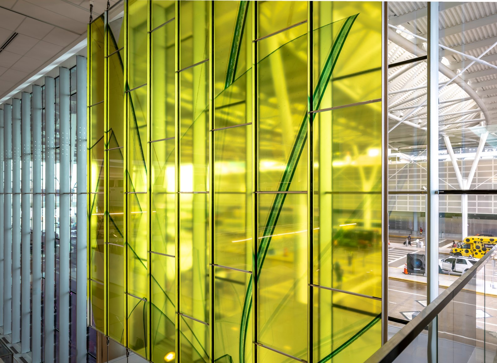 Marta Chilindron, Unexpected Spaces, 2025. Digital print on glass and polished stainless steel, 21&rsquo; x 20&rsquo; (yellow), 21&rsquo; x 35&rsquo; (green), 15&rsquo; x 27&rsquo; 6&rdquo; (blue). Permanent installation at George Bush Intercontinental Airport (IAH), Terminal E. Image courtesy of Houston Airports. Photos by Slyworks.