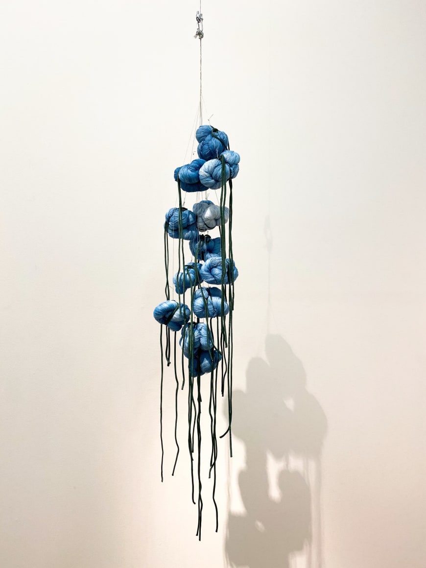 Sandra Monterroso, Puntos en resistencia azul. Edition. 2/13, 2019. Installation Indigo dyed yarn, loop, steel rope, 13 knots, 53 x 8 x 8 in. (134.6 x 20.3 x 20.3 cm.)