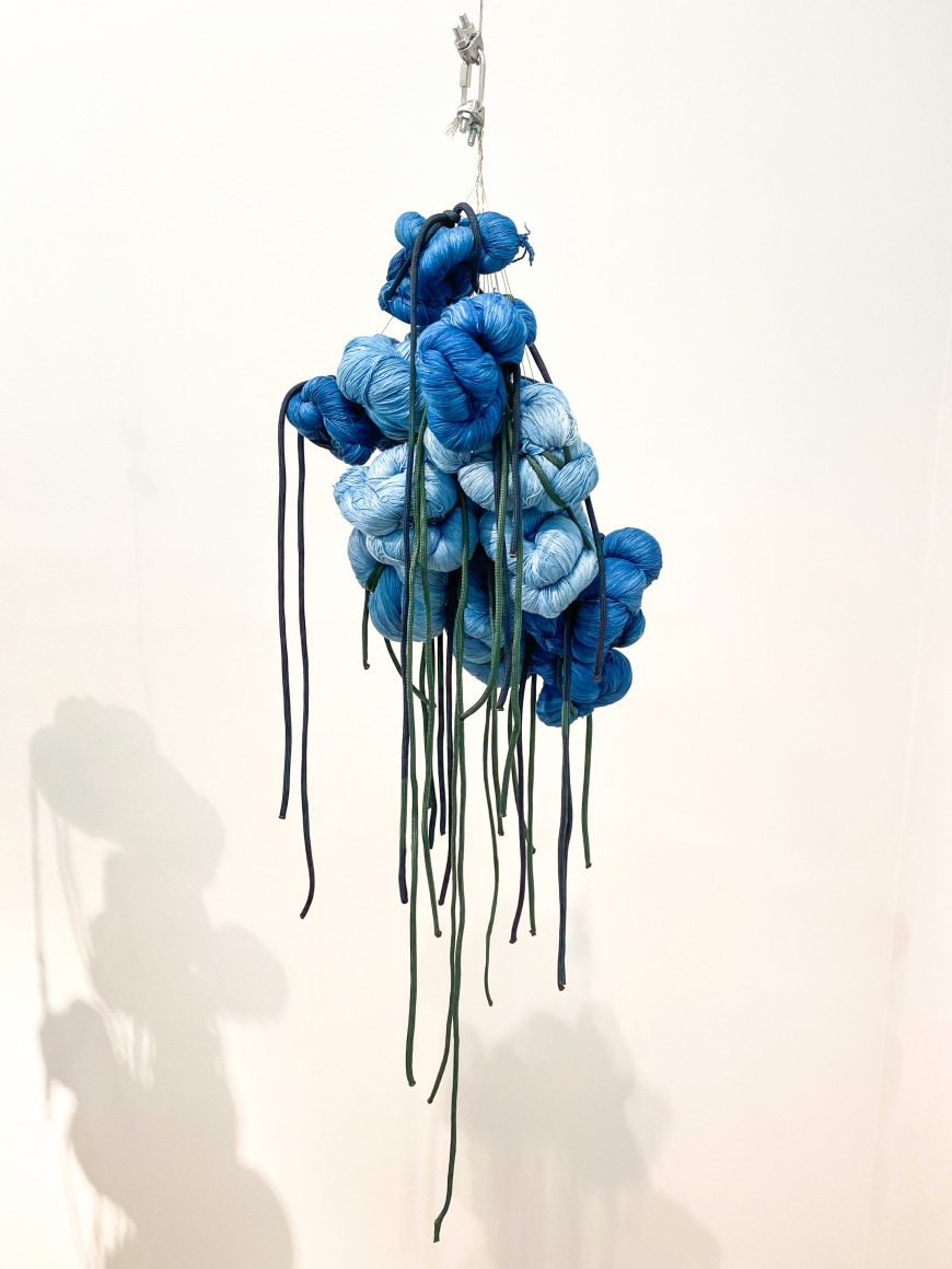 Sandra Monterroso, Puntos en resistencia azul. Edition. 6/13, 2019. Installation Indigo dyed yarn, loop, steel rope, 13 knots, 53 x 8 x 8 in. (134.6 x 20.3 x 20.3 cm.)